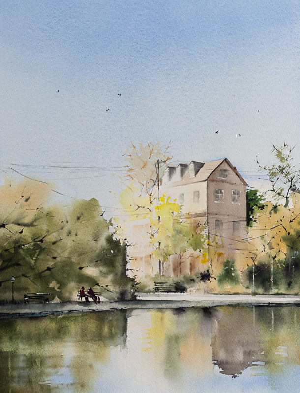 Original watercolor painting titled Colonial Lake showing a soft Charleston landscape with a house beside the lake, trees, benches, and reflections in the water under a pale blue sky.