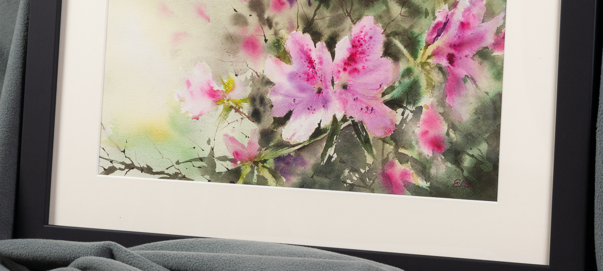 Detail view of framed pink azalea watercolor art showing delicate floral texture, white mat, and soft Southern spring colors.